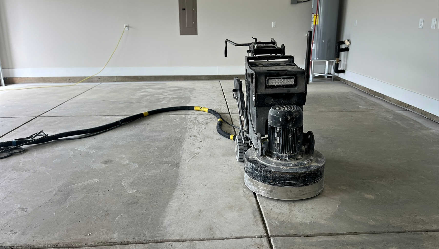 concrete-preperation-charlotte-nc A garage floor being grinded down in preparation for an epoxy floor coating.